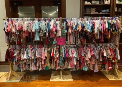 Large assortment of girls clothes on a rack