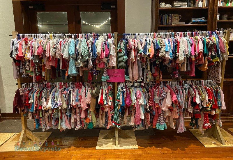Large assortment of girls clothes on a rack