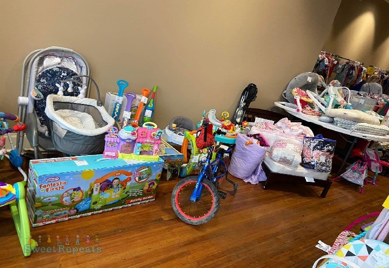 Picture of a kids bicycle, doll bed and baby swing